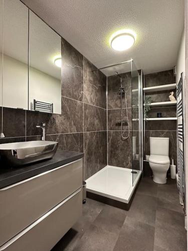 a bathroom with a shower and a sink and a toilet at Sea View Apartment Poole Quay - FREE Parking in Poole