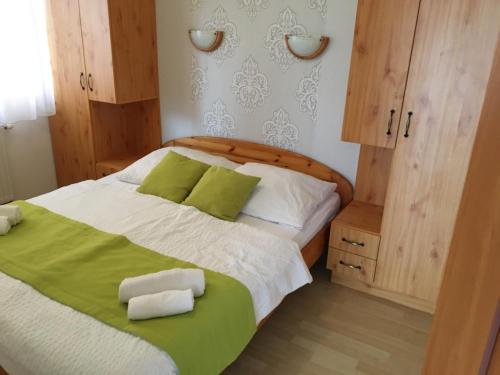 a bedroom with a bed with two towels on it at Central Apartments in Zalakaros