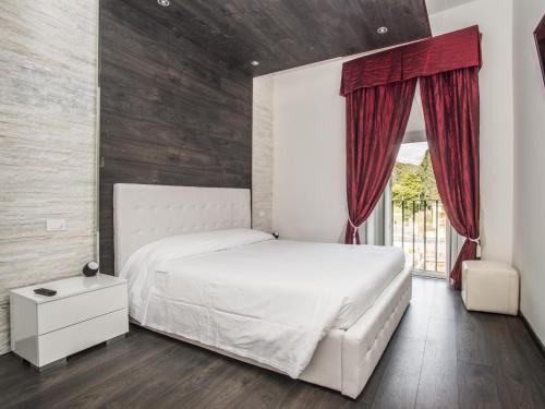 a bedroom with a white bed and a window at Royal Rooms in Rome