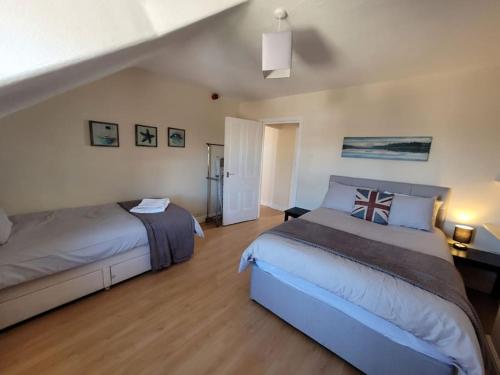 a bedroom with two beds in a room at Spacious cosy apartment in Llandudno