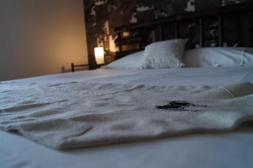 a close up of a white blanket on a bed at Domaine de Kerzuat in Plouarzel