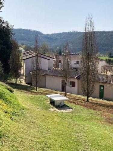a park with a bench in the middle of a field at CONFORTABLE MAISON DANS VILLAGE VACANCES AVEC PISCINE A CAJARC in Cajarc