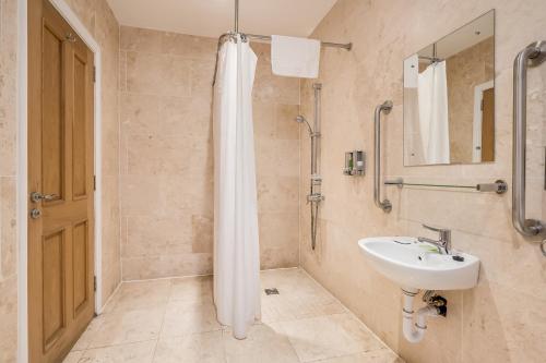 a bathroom with a shower and a sink at Central Belfast Apartments Harpers in Belfast
