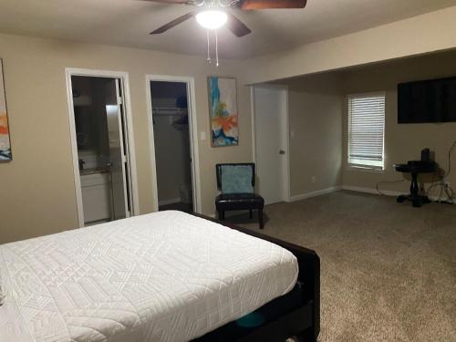 a bedroom with a bed and a ceiling fan at Stunning Family Home in North Houston!!! - Briar Creek in Spring