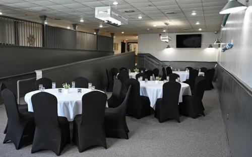 a conference room with tables and chairs and a tv at Harbor Shores on Lake Geneva in Lake Geneva