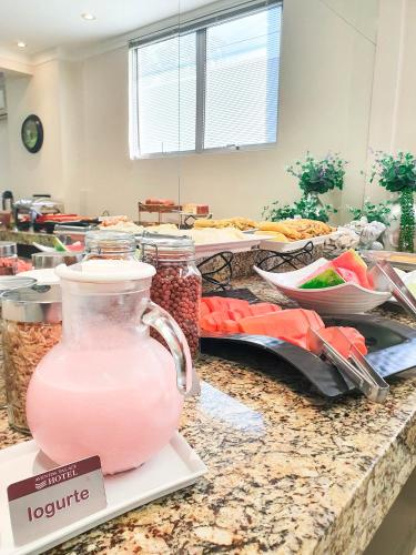 a jug of pink liquid sitting on a counter at Avenida Palace Hotel in Joinville