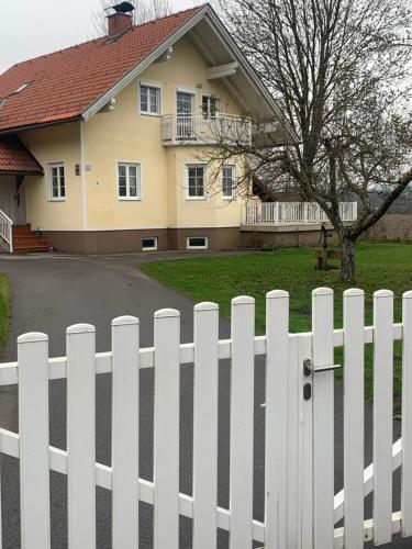 a white picket fence in front of a house at Ferienhaus Loretto in Wölzing