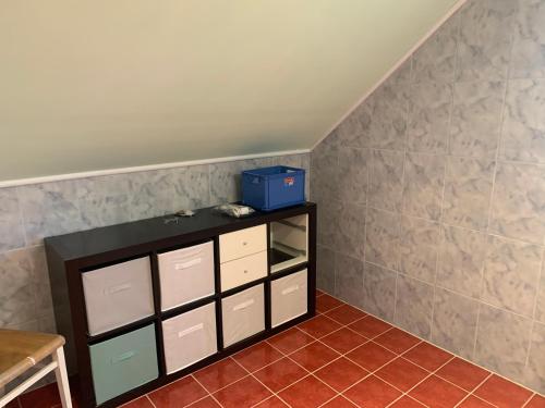a room with a shelf with white drawers and a table at Ferienhaus Loretto in Wölzing