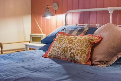 a blue bed with pillows on top of it at Star Cottage in Whitstable