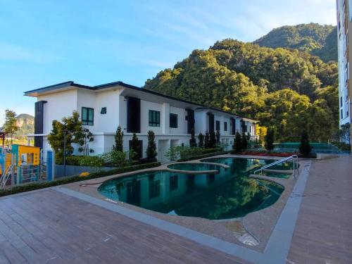 a swimming pool in front of a house at Hotspring 2 Room Suite 1912 @ Sunway Onsen (Neighbour of Lost World of Tambun) in Ipoh