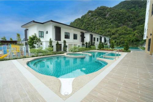 a large swimming pool in front of a house at Hotspring 2 Room Suite 1912 @ Sunway Onsen (Neighbour of Lost World of Tambun) in Ipoh