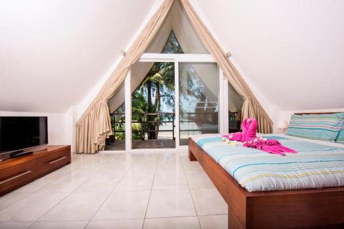 a bedroom with a bed and a large window at Siam Sunset Beach Villas in Ko Chang