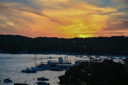 a group of boats docked in a harbor at sunset at Harbor Shores on Lake Geneva in Lake Geneva