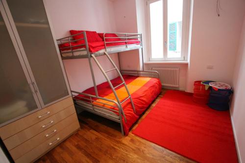 a bedroom with two bunk beds and a window at Cernobbio 2 Bedroom Apartment in Cernobbio