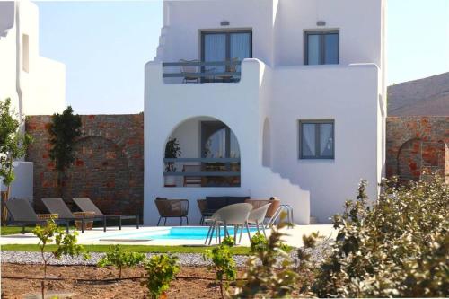 a white house with a pool in front of it at The Nine Graces - Kastraki Villas with Private Swimming Pool in Kastraki Naxou
