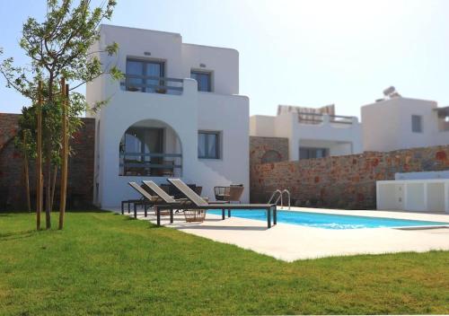 a villa with a swimming pool in front of a house at The Nine Graces - Kastraki Villas with Private Swimming Pool in Kastraki Naxou