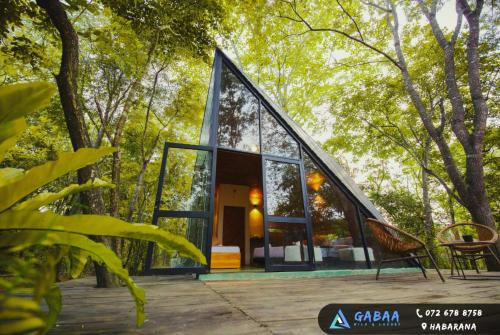 a glass house in the middle of a forest at Gabaa Resort & Spa - Habarana in Habarana