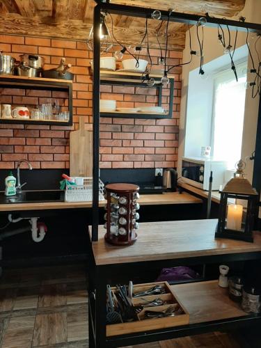 a kitchen with a table and a counter top at Agroturystyka Siedlisko in Kowiesy