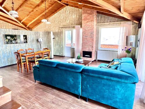 a living room with a blue couch and a table at Penthouse Apartment 401 in Tbilisi City