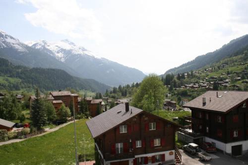 a view of a village with mountains in the background at Hotel Fiescherhof in Fiesch
