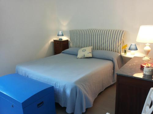 1 dormitorio con 1 cama y 1 mesa con 2 lámparas en Il Cinqualino locazione turistica, en Cinquale