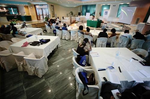 a group of people sitting at tables in a room at Hotel Club San Diego in Maratea
