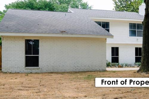 a white brick house with a front of progress at Stunning Family Home in North Houston!!! - Briar Creek in Spring