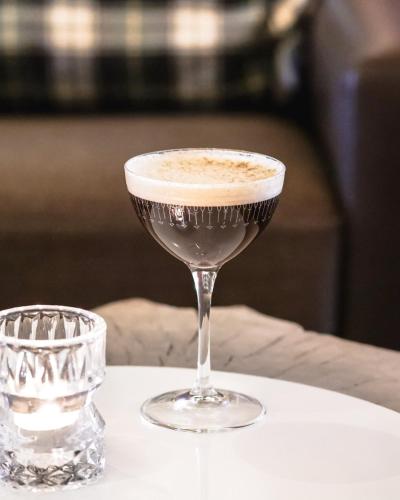 a drink in a martini glass on a table at Mercure Saint-Lary in Saint-Lary-Soulan