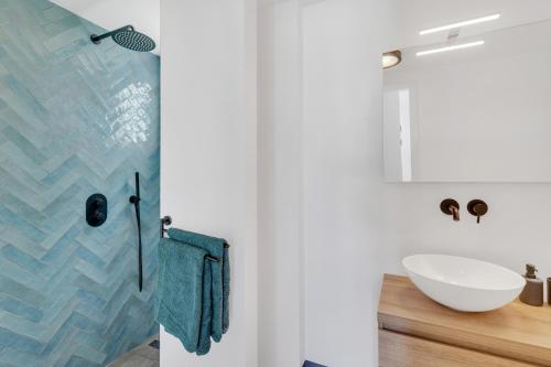 a bathroom with a sink and a mirror at New & luxurious Two Bedroom Apartment at the Water in Kralendijk