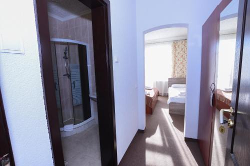 a bathroom with a shower and a mirror in a room at Hotel Continent in Polyana