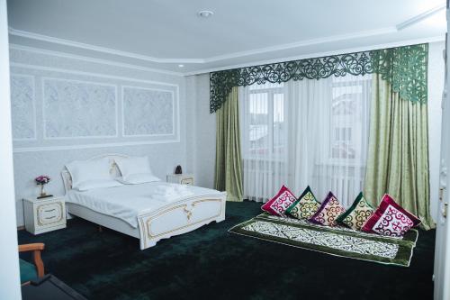 a bedroom with a white bed and a window at SELFIE + in Semey