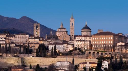 a view of a city with buildings and mountains at B&B Sotto le Mura in Bergamo
