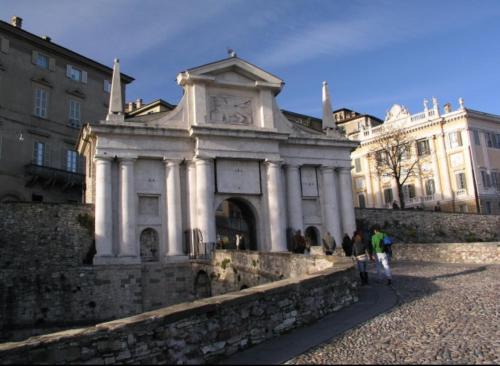 a building with a clock tower on top of a wall at B&B Sotto le Mura in Bergamo