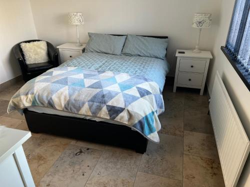 a bedroom with a bed and two night stands at Green Monkey Lodge in British