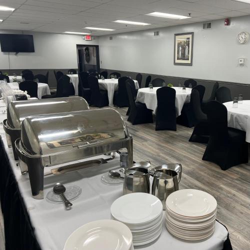 a dining room with white plates on a table at Harbor Shores on Lake Geneva in Lake Geneva