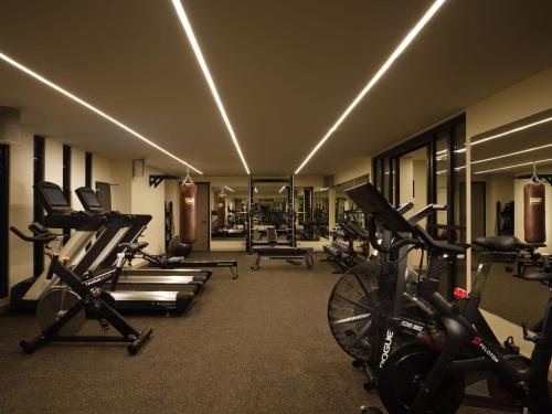 a gym with bikes and tread machines in a room at The Other House South Kensington in London
