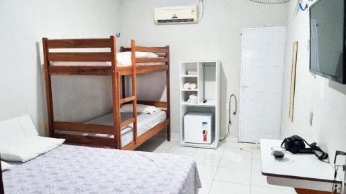 Ένα ή περισσότερα κρεβάτια σε δωμάτιο στο Pousada Sol Dourado