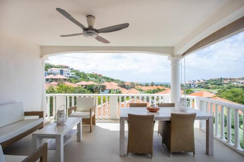 a patio with a table and chairs on a balcony at Blue Bay Apartments in Sint Michiel