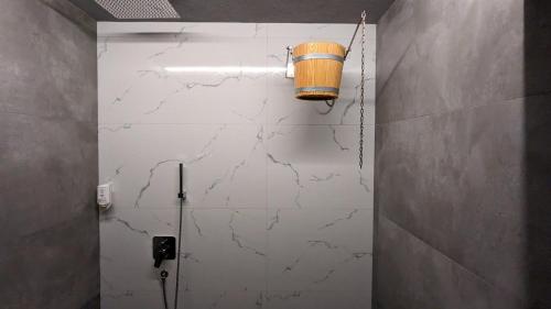 a bathroom with a toilet with a bucket on the wall at TheHouse - Apartment Kamenitza in Velingrad