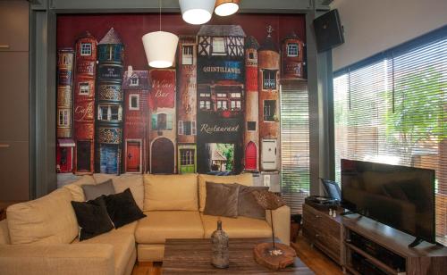 un soggiorno con divano e parete con murale di Euzoia luxury maisonette a Chania