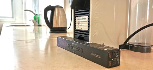a box sitting on a counter next to a microwave at Large apartment with sea view in Bat Yam