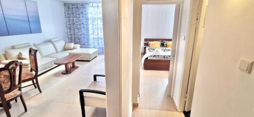 a living room with a couch and a table at Large apartment with sea view in Bat Yam