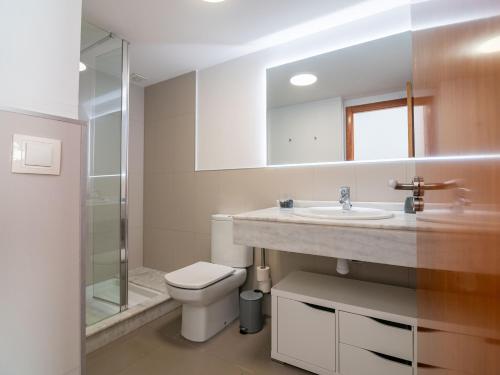a bathroom with a toilet and a sink and a shower at Loft Valterna 9 in Paterna