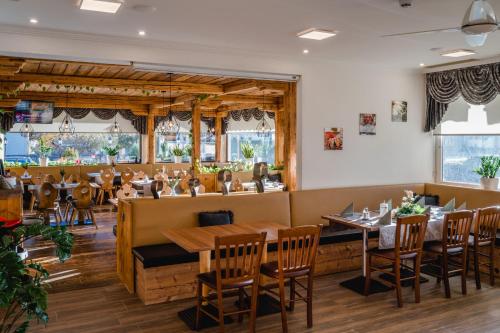 a dining room with wooden tables and chairs at Haiminger Hof in Haiming