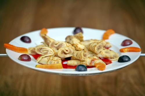 a white plate of food on a wooden table at Best Western Hotel Peine Salzgitter in Peine