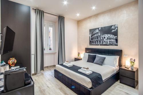 1 dormitorio con 1 cama y TV y un edificio en Tacito 23 Luxury rooms en Roma