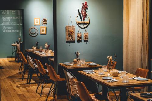 a dining room with long tables and chairs at Hotel Sportalm - Adults Only Boutique Hotel in Bad Kleinkirchheim