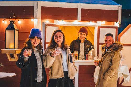 a group of people holding wine glasses in front of a bar at Hotel Sportalm - Adults Only Boutique Hotel in Bad Kleinkirchheim