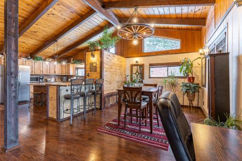 a kitchen with wooden ceilings and a table and chairs at Hilltop Hideaway in Bigfork