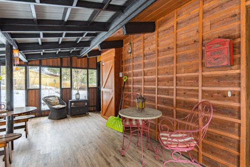 a room with wooden walls and a table and chairs at Hilltop Hideaway in Bigfork